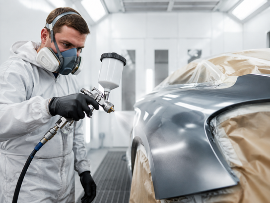Automotive spray painting in a professional spray booth